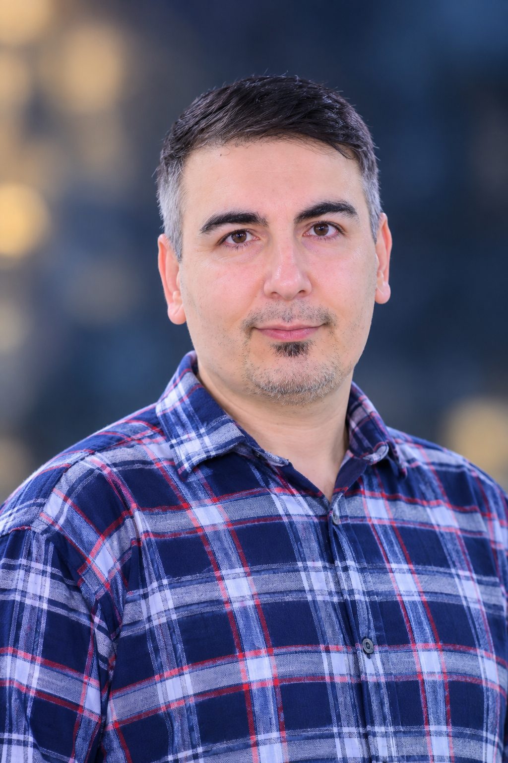 Portrait of Meraj Hadad in a checked shirt, creator of MHADAD.IR online tools
